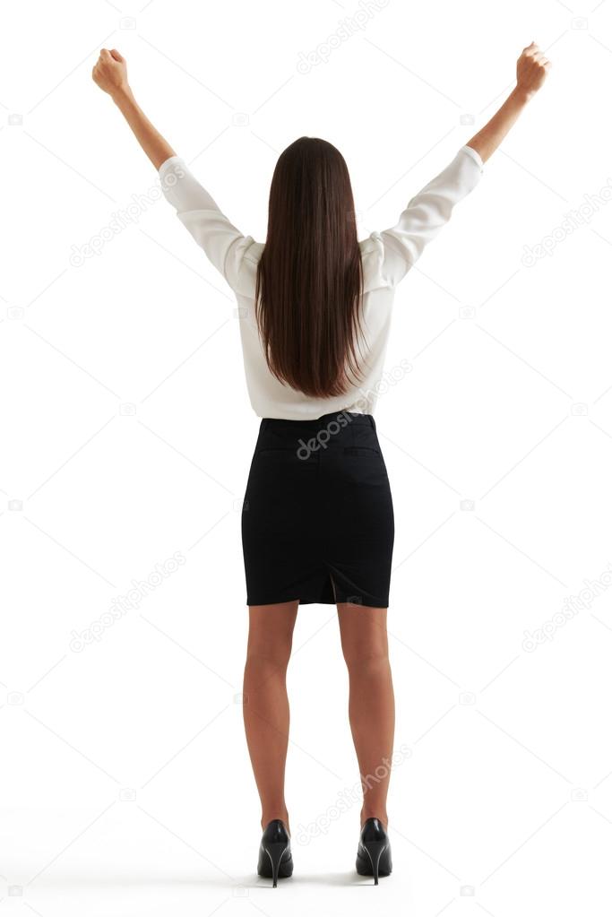 woman in formal wear raising her hands up