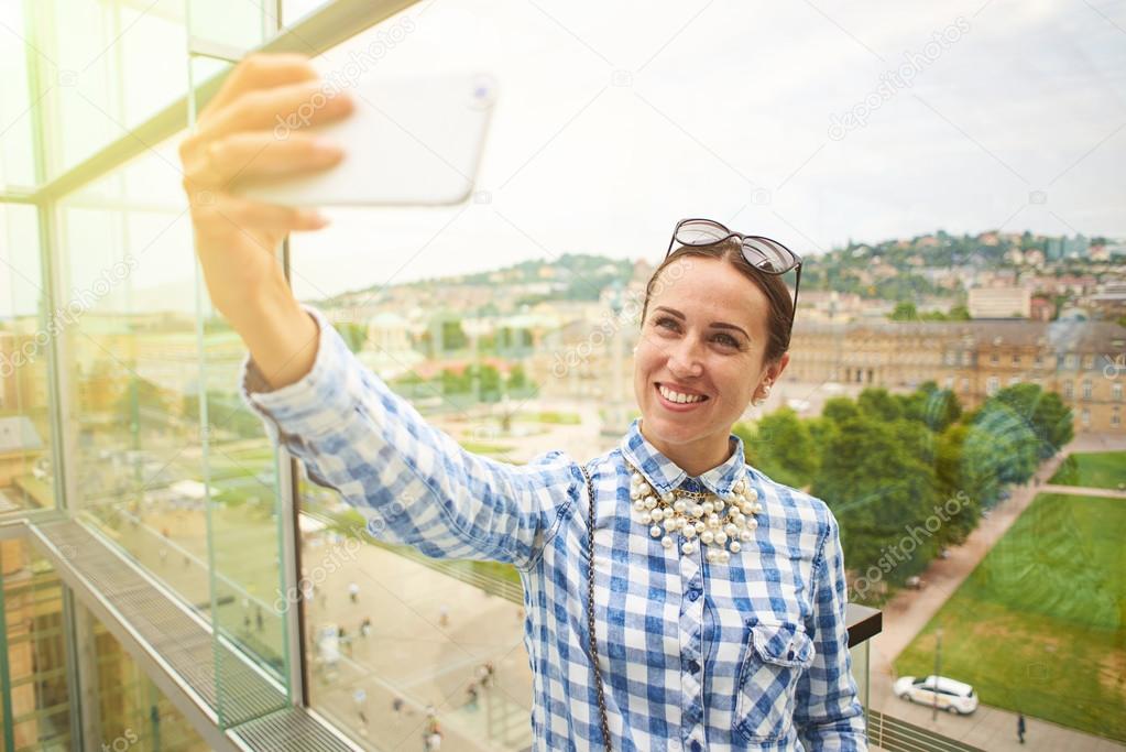 woman taking selfie against urban landscape