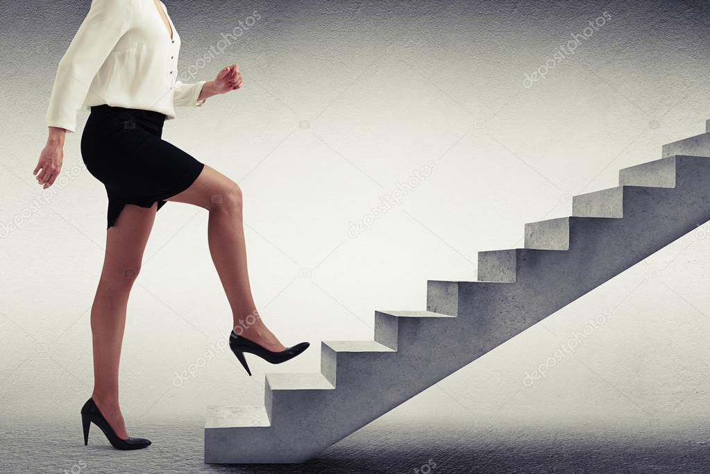 woman in formal wear walking up stairs