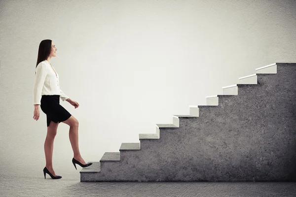Woman walking up concrete stairs — Stock Photo, Image