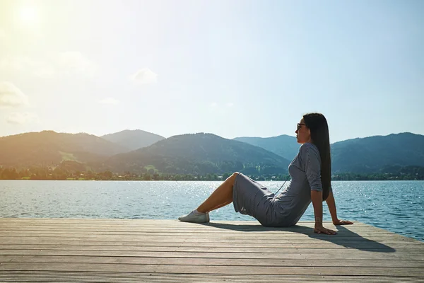 Young woman relaxing on moorage — Stock Photo, Image