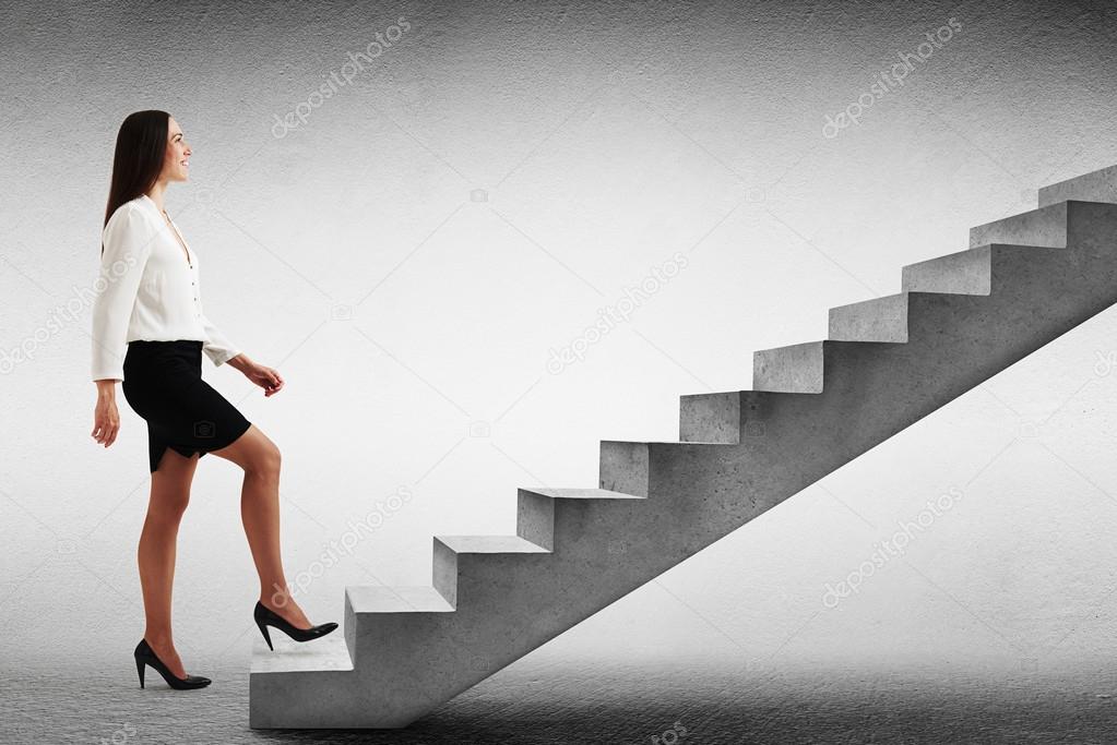 woman walking up concrete stairs