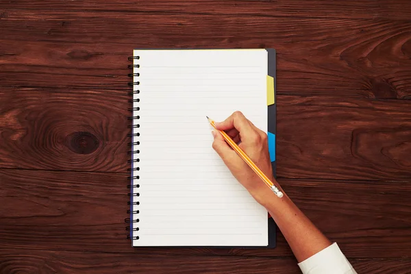 Top view of womans hand holding pencil — Stock Photo, Image