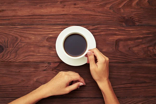 Woman holding cup of black coffee — Stock Photo, Image