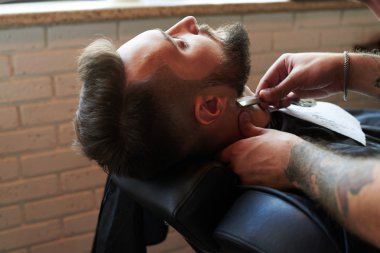 barber shaving with vintage straight razor clipart