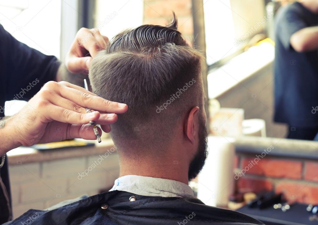barber cutting hair with scissors
