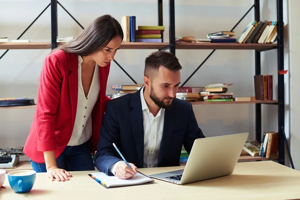 Homem concentrado e mulher olhando para laptop — Fotografia de Stock