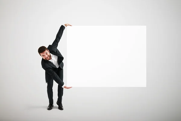 Geschäftsmann mit großem weißen Banner — Stockfoto