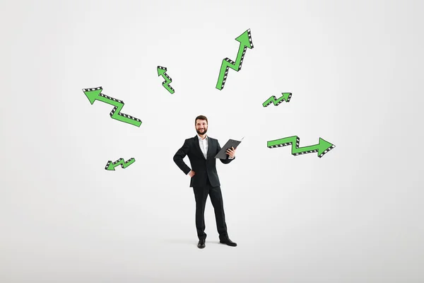 Man with black folder and green arows — Stock Photo, Image