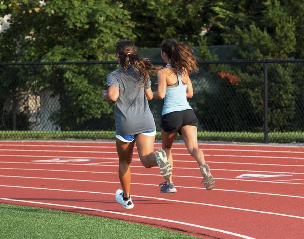 Rear View Two High School Girls Running Together First Turn — Stock Photo, Image