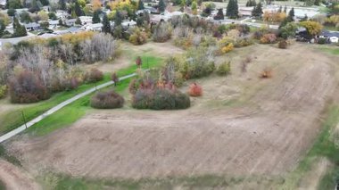 River Heights Saskatoon 'un sonbaharda çekilmiş renkli ağaçlar, evler ve nehir manzaralı klibi..