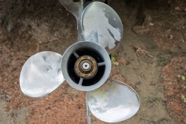 Propeller is shown with a brownish color background. The propeller is old and rusty