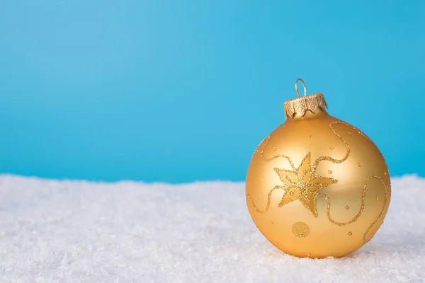 Merry Christmas eve noel concept. Close up photo picture of single beautiful tree decor ball with shiny ornament lie on soft snow