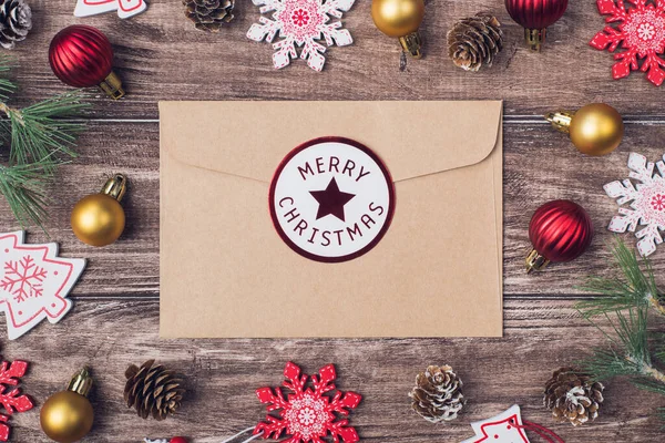 Writing letter to santa claus concept. Top above photo image of craft envelope with tag congrats and beautiful christmas accessories on wood rustic desk