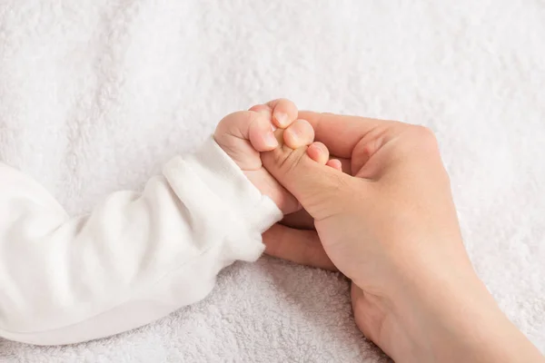 Closeup Photo Newborn Small Hand Clenching Mother Thumb Isolated White — Stock Photo, Image