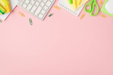 Top view photo of green and yellow stationery organizers pens clips pushpins scissors ruler stickers eraser keyboard and mouse on isolated pastel pink background with copyspace clipart