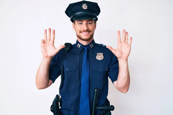 Young caucasian man wearing police uniform showing and pointing up with fingers number nine while smiling confident and happy.