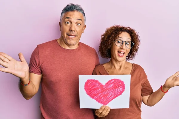 Beautiful Middle Age Couple Holding Heart Draw Celebrating Achievement Happy — Stock Photo, Image