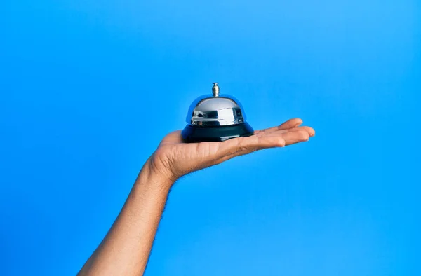 Junge Hispanische Hand Hält Alarmglocke Über Isoliertem Blauen Hintergrund — Stockfoto