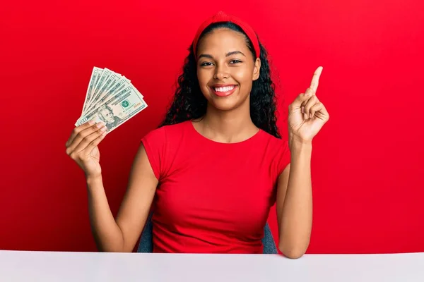 Young African American Girl Holding Dollars Sitting Table Smiling Happy — Stock Photo, Image