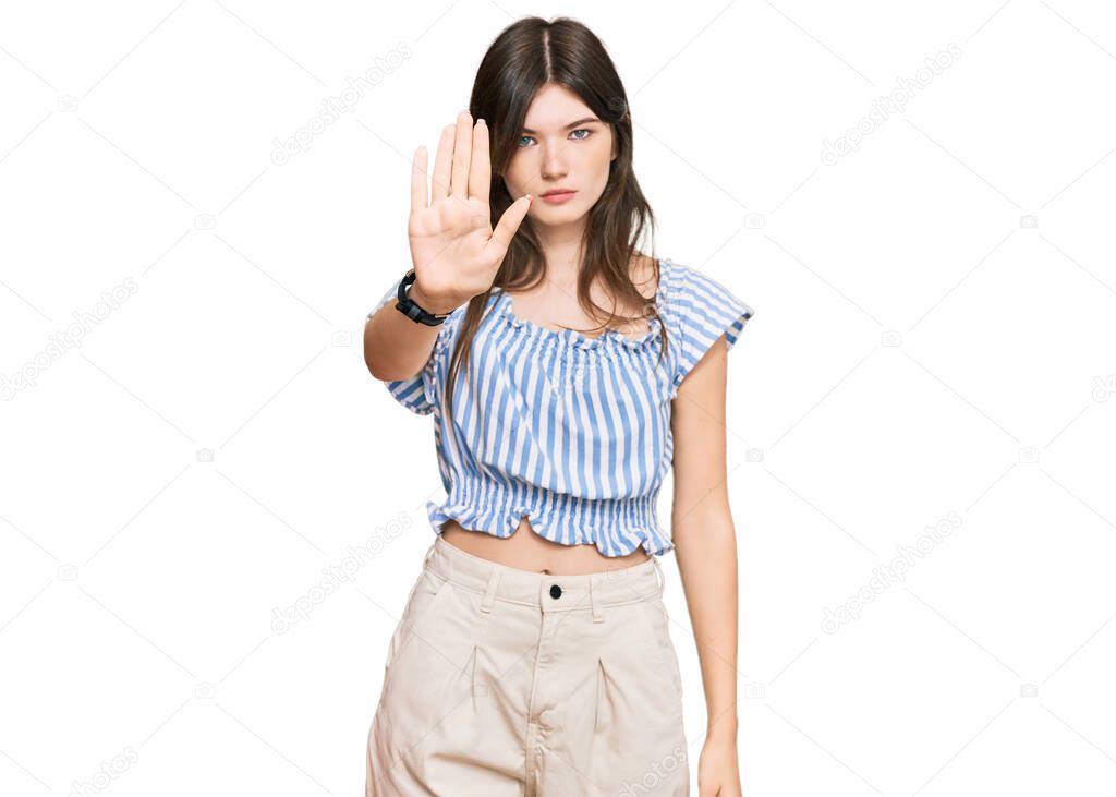 Young beautiful caucasian girl wearing casual clothes doing stop sing with palm of the hand. warning expression with negative and serious gesture on the face. 