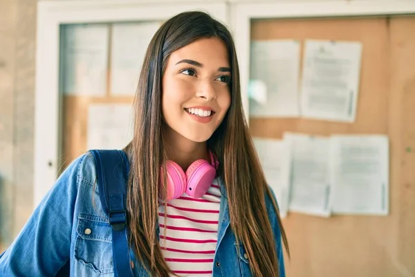 若いですヒスパニック系の学生女の子笑顔幸せな使用してヘッドフォン歩行で街 — ストック写真