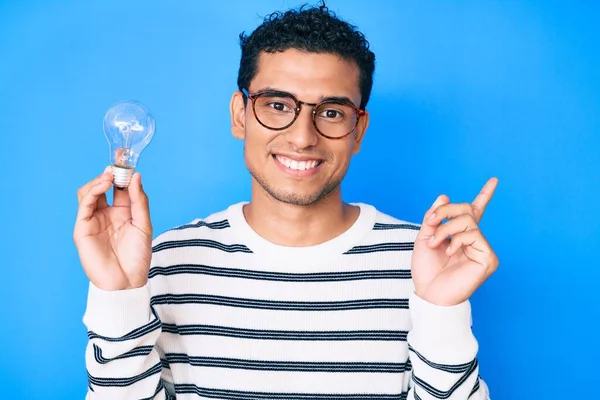 Junger Schöner Hispanischer Mann Mit Glühbirne Als Inspiration Und Idee — Stockfoto