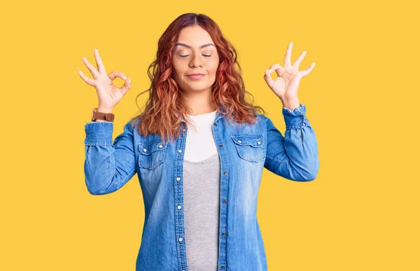 Young latin woman wearing casual clothes relax and smiling with eyes closed doing meditation gesture with fingers. yoga concept.