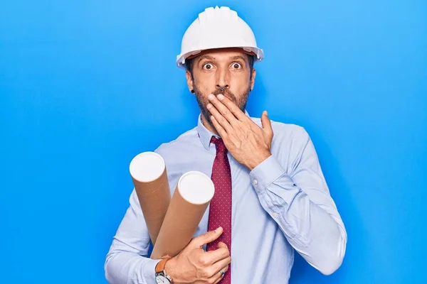 Young Handsome Man Wearing Architect Hardhat Holding Blueprint Covering Mouth — Stock Photo, Image