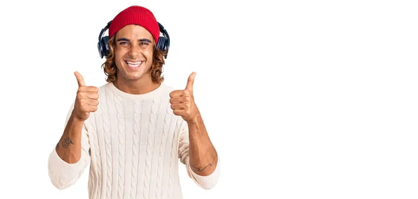 Young Hispanic Man Listening Music Using Headphones Success Sign Doing — Stock Photo, Image