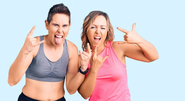 Couple Women Wearing Sportswear Shouting Crazy Expression Doing Rock Symbol — Stock Photo, Image