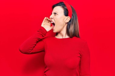 Genç ve güzel bir kadın gündelik kıyafetler giyip el ele tutuşarak bağırıyor ve çığlık atıyordu. iletişim konsepti. 