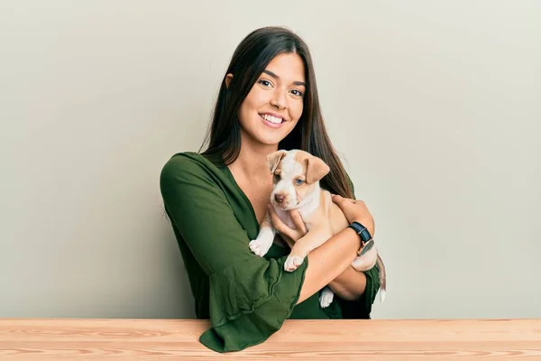 Young Hispanic Girl Smiling Happy Hugging Dog Sitting Table Isolated — Stock Photo, Image