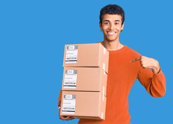 Young African Amercian Man Holding Delivery Package Pointing Finger One — Stock Photo, Image