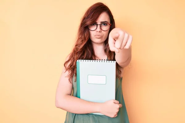 Young Beautiful Woman Wearing Glasses Holding Book Pointing Finger Camera — Stock Photo, Image