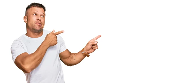 Handsome Muscle Man Wearing Casual White Tshirt Pointing Aside Worried — Stock Photo, Image