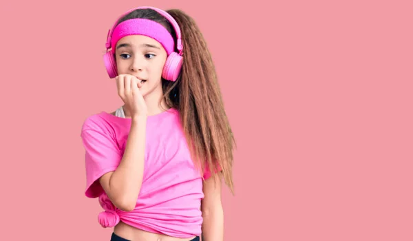Cute Hispanic Child Girl Wearing Gym Clothes Using Headphones Looking — Stock Photo, Image