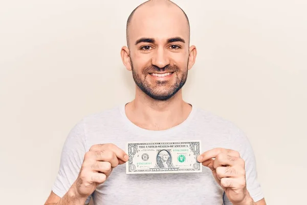 Jovem Careca Bonito Segurando Uma Nota Dólar Olhando Positivo Feliz — Fotografia de Stock