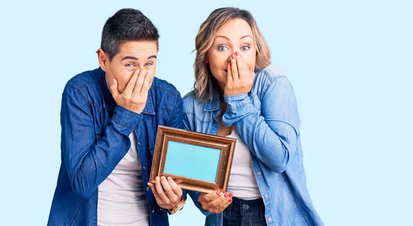 Couple Women Holding Empty Frame Laughing Embarrassed Giggle Covering Mouth Stock Photo