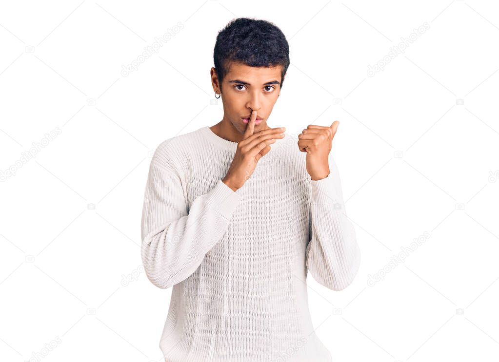 Young african amercian man wearing casual clothes asking to be quiet with finger on lips pointing with hand to the side. silence and secret concept. 