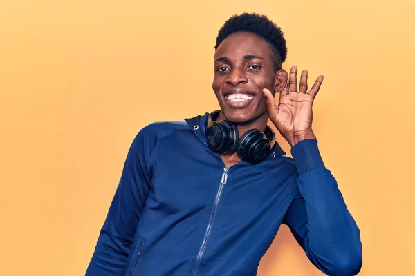 Young African American Man Wearing Sportswear Headphones Smiling Hand Ear — Stock Photo, Image