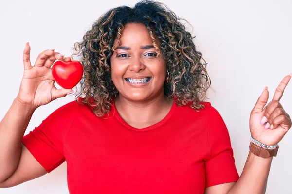 Joven Afroamericano Más Tamaño Mujer Sosteniendo Corazón Sonriendo Feliz Señalando —  Fotos de Stock