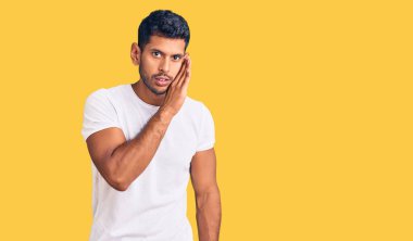 Genç latin adam gündelik giysiler giyip el ele tutuşuyor gizli söylentiler yayıyor, kötü niyetli konuşmalar fısıldıyor. 