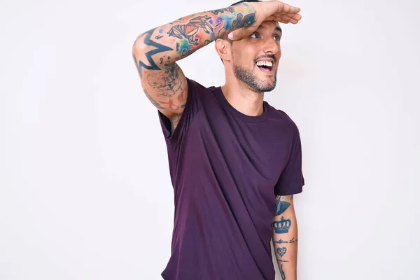 タトゥーの若いハンサムな男は非常に幸せと笑みを浮かべて離れて手を頭の上に見てカジュアルな服を着て 検索の概念 — ストック写真