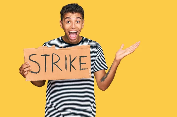 Young Handsome African American Man Holding Strike Banner Cardboard Celebrating — Stock Photo, Image