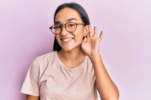 Mladá Asiatka Neformálním Oblečení Brýlích Usmívá Rukou Přes Ucho Poslouchá — Stock fotografie