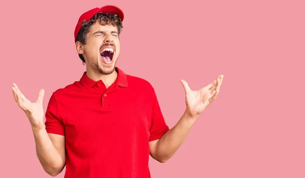 Young Handsome Man Curly Hair Wearing Delivery Uniform Crazy Mad — Stock Photo, Image