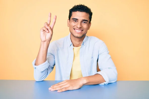Young Handsome Hispanic Man Wearing Casual Clothes Sitting Table Smiling — Stock Photo, Image