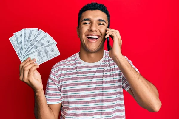 Young Arab Man Having Conversation Talking Smartphone Holding Dollars Smiling — Stock Photo, Image