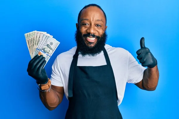 Young African American Man Wearing Professional Apron Holding Usa Dollars — Stock Photo, Image
